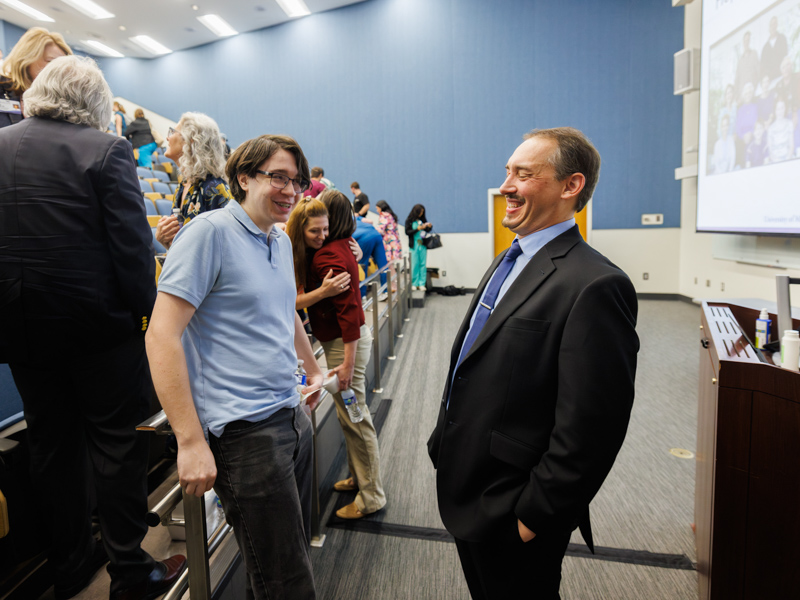 Dr. Tullos gleefully connects with medical student Aiden Leise after his Last Lecture, extending the conversation beyond the lectern.