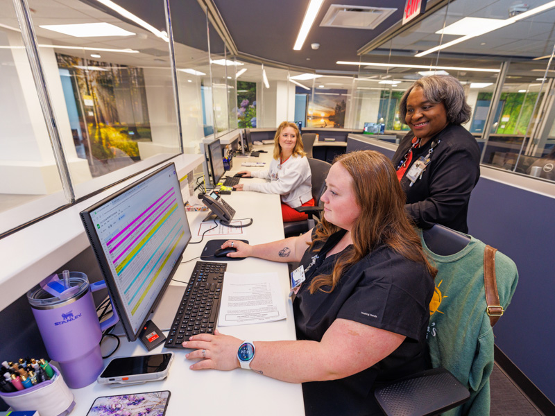 Winford reviews the schedule with from left; Cara Bristow and Brooke Nichols, both nurse graduates.