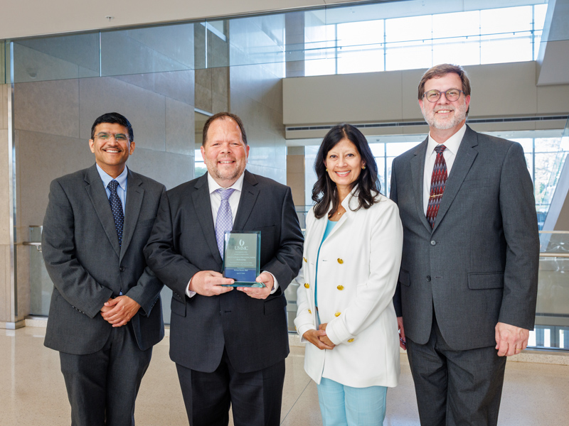From left, Dr. Amol Janorkar, chair of the Department of Biomedical Materials Science; Dr. Michael D. Roach; Dr. Pia Chatterjee Kirk, dean of the School of Dentistry; and Dr. Jason Griggs, associate dean for research in the School of Dentistry, attend a ceremony recognizing the establishment of the Lyle D. Zardiackas, PhD, FADM, FASTM Professorship in Biomedical Materials Science.