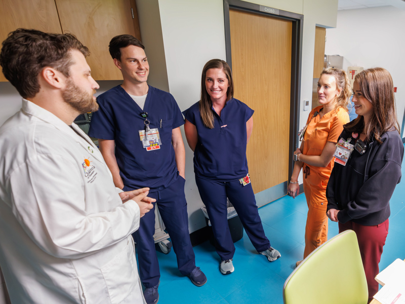 PICU nurse manager Gordon Gartrell, from left, talks with registered nurses Christian Dulaney, Emily Wade, Alexis Gaines and Haley Williams.