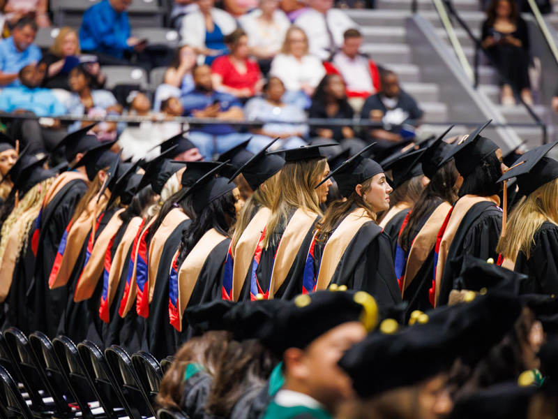 Standing in solidarity, MSN graduates exhibit pride in their accomplishments.