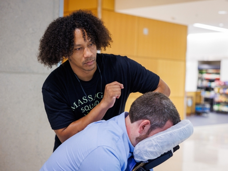 Padre Parkman of Therapeutic Connection gives a chair massage that relieves stress and gives a quick energy fix to UMMC employee Jonathon Nutt during 2026 Employee Appreciation Week. Jay Ferchaud/ UMMC Communications
