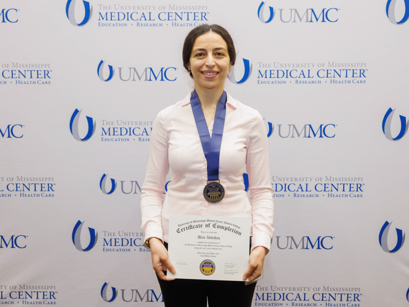 Honors College member Mais Abdelhaq of the 2025–2026 Honors College Program poses with her certificate and medallion.