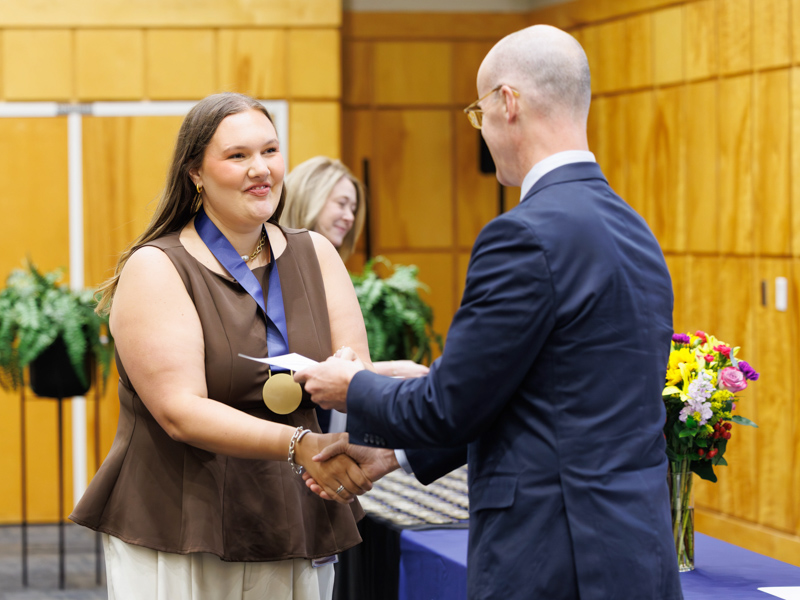 Dr. Scott Rodgers presented a certificate to inaugural 2024-2025 Honors College class member Kaitlyn Quick, an awardee in the School of Health Related Professions Doctor of Occupational Therapy program.