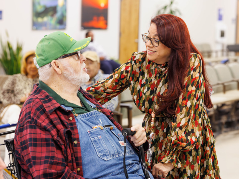 Earl Aldridge, a CCRI patient from Pearl, talks with Rios.
