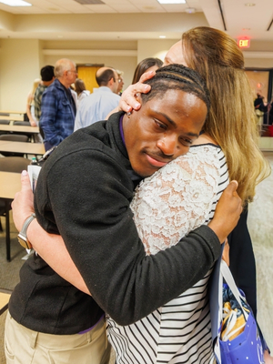 2026 Project SEARCH graduate Dai'Jawn "Bizzy" Smith gets a hug from Lisa Baldwin, one of his teachers at Pearl High School, after Friday's ceremony.