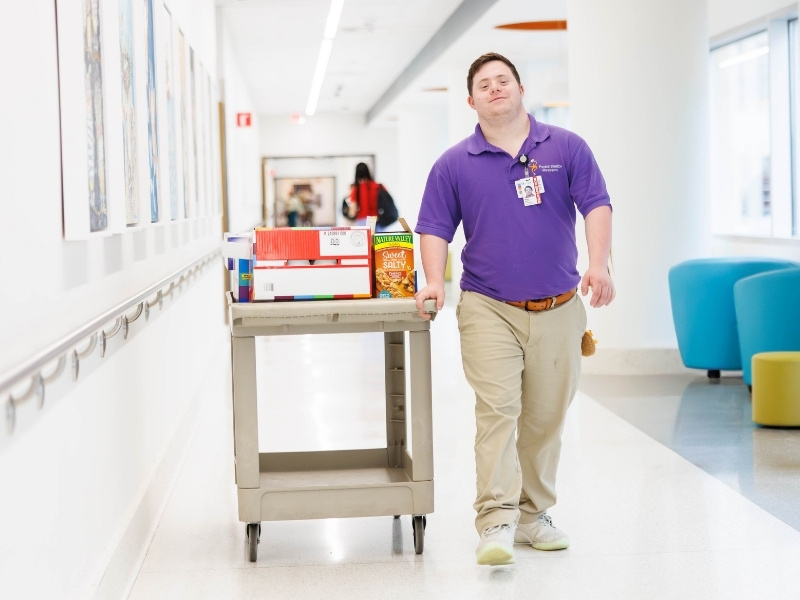 Nick Weldon distributes snacks to Sanderson as a part of the Project Search internship with volunteer services