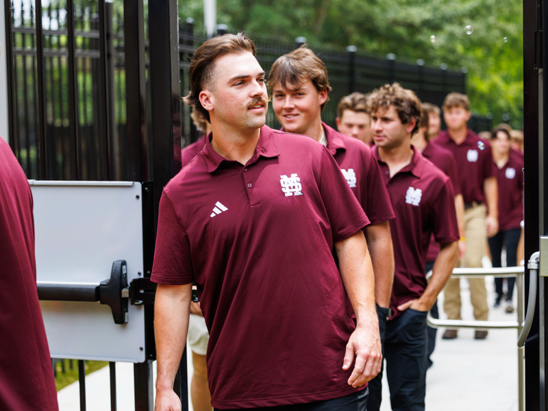 MSU baseball player Noah Sullivan and fellow players enter Mimi's playground for a visit with patients.