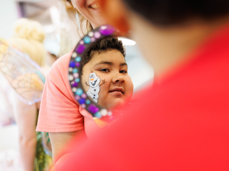 Caleb Cruz, 9, of Ridgeland admires his Olaf face paint at Disney Day hosted in the Sanderson Tower Community Room at the children's hospital.