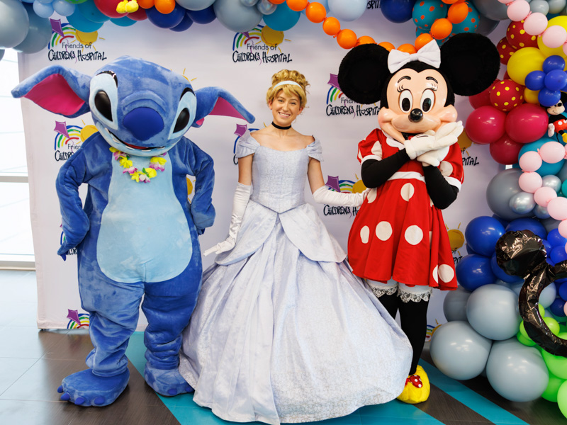Stitch, Cinderella and Minnie Mouse pose for a photo at Disney Day, hosted by Friends of Children's Hospital, for parents in the Sanderson tower community room.
