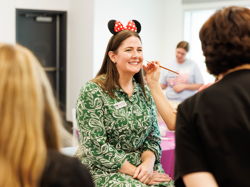 Caitlin Foreman, executive director of Friends of Children's Hospital has her face painted at Disney Day hosted by Friends of Children's Hospital.