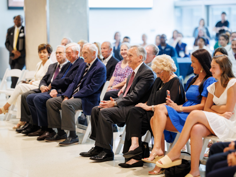 Dr. Hall and his wife, Becky, struggle to contain their laughter as a speaker recounts one of the many entertaining stories from Hall's decades at UMMC. Joe Ellis/ UMMC Communications
