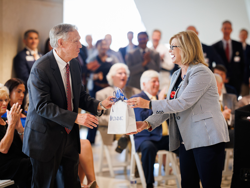 Dr. LouAnn Woodward presents Dr. Hall with a watch – “or two” – in recognition of his many years of dedicated service to UMMC. Joe Ellis/ UMMC Communications