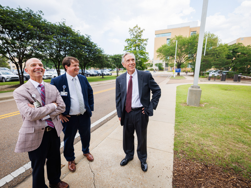 Dr. Alan Jones, left, associate vice chancellor of health affairs, Dr. Lee Bidwell and Dr. Hall admire the building that now bears Hall's name Joe Ellis/ UMMC Communications
