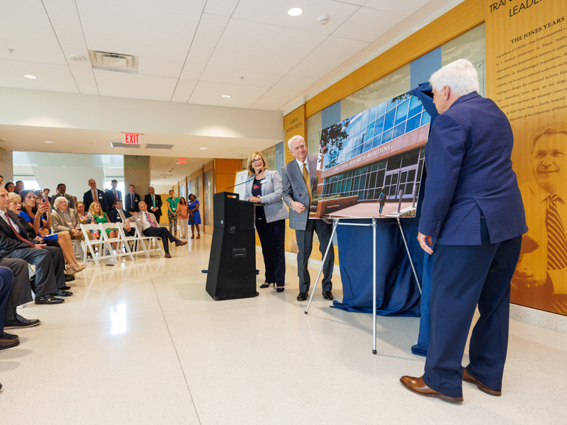 Dr. LouAnn Woodward, Dr. Dan Jones, and Dr. Joey Granger, unveil the John E. Hall Research Building. Jay Ferchaud/ UMMC Communications