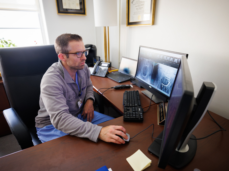 Dr. David Mittwede, an orthopaedic trauma surgeon, reviews post-operative images of patient Latravis Bell's pelvic injury.