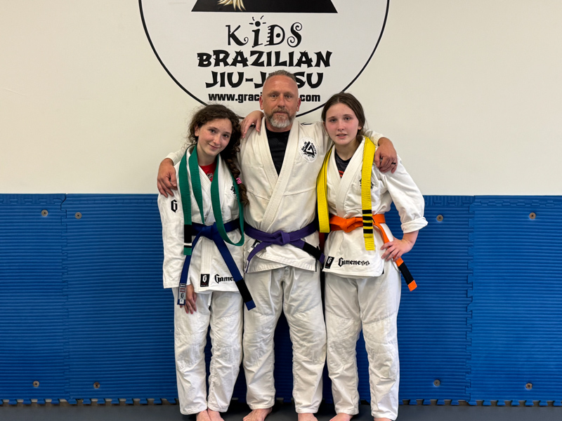 Smith, chief nursing officer at the children’s hospital poses with his daughters from left Ainsley Smith, 14, and Adeline Smith, 17, after they were promoted in Jiujitsu. 