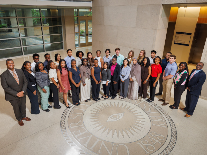 Thirty-two participants representing 11 colleges and universities in this year’s P.R.O.M.I.S.E. Program pose for a group photo with Dr. Demondes Haynes and Dr. Dan Coleman during an early program gathering highlighting the start of their academic and clinical enrichment experience.