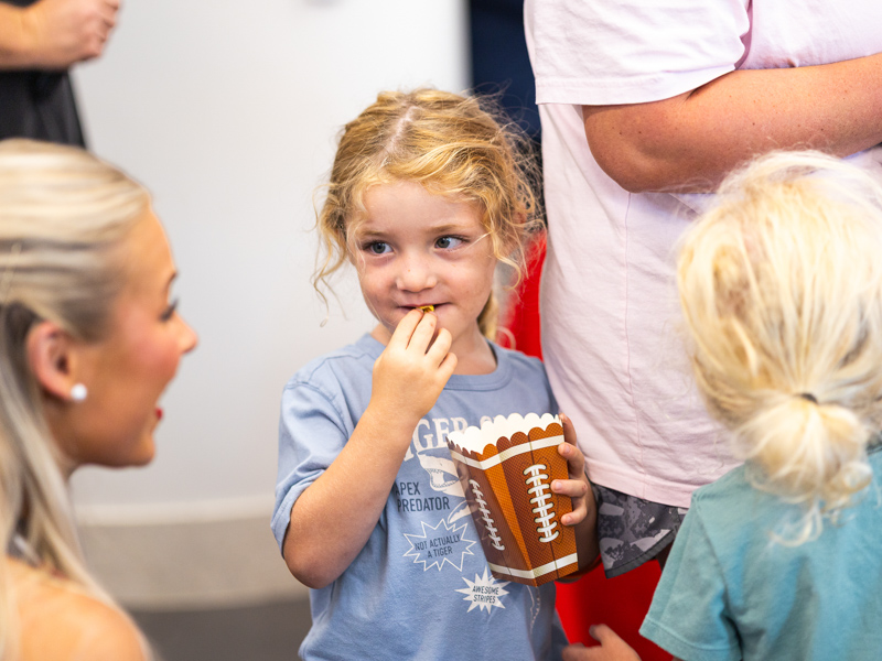 Dustin Osborne, 3, of Philadelphia meets an Ole Miss cheerleader with his brother, Graham.