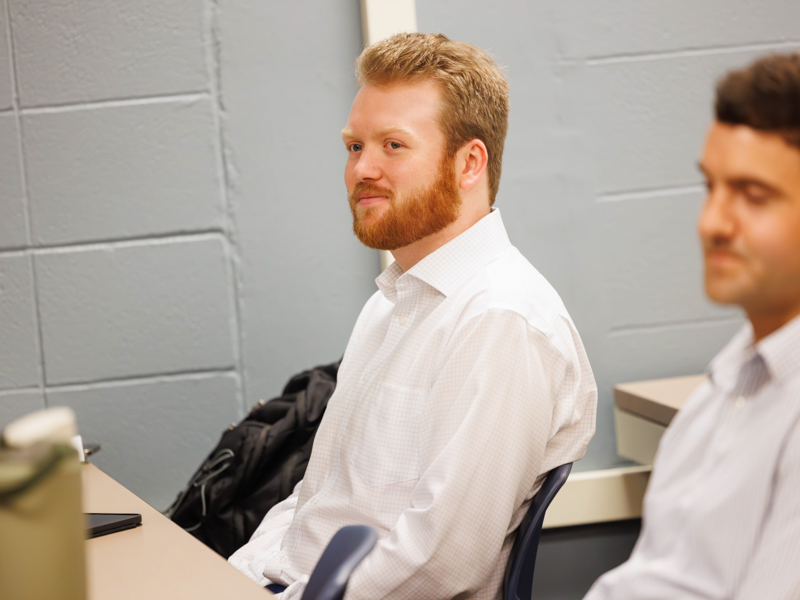 Matt Burnham, left, listens during a chat with fellow students and others during CRNA orientation Aug. 10.