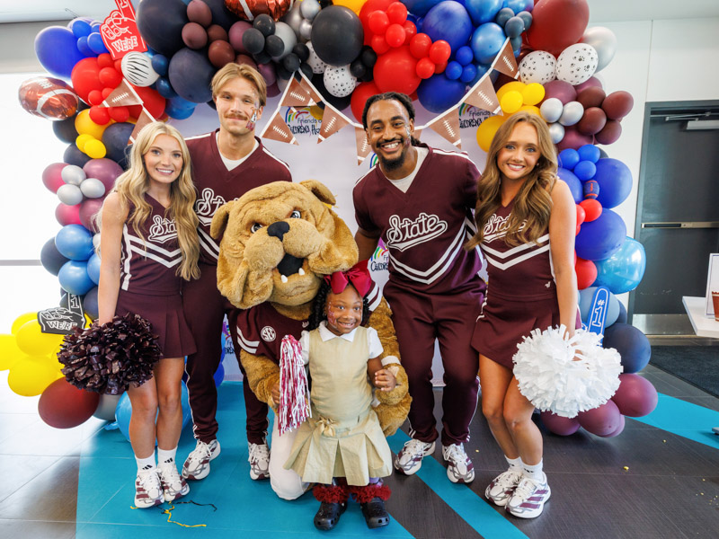 Cassidy Bough, 6, of Waynesboro shows off her Mississippi State University spirit to cheerleaders and Bully Bulldog.