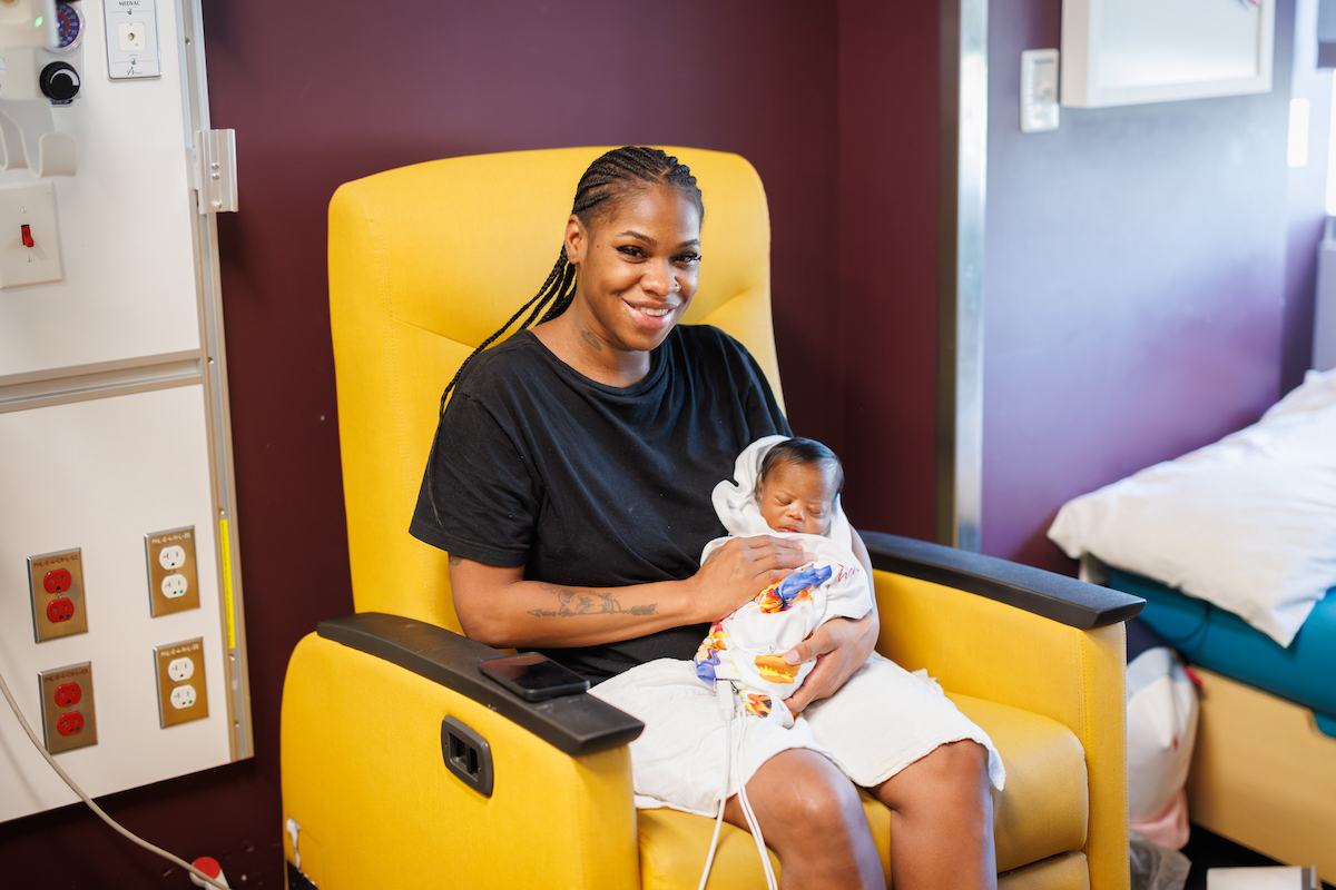 Zephaniah Blair and his mom Shaneika of Jackson wait patiently for their books to read.
