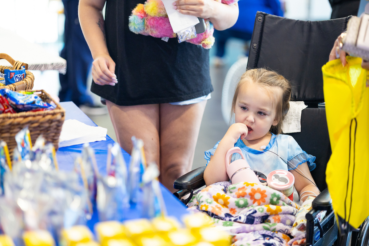 Kensley Seros, 4, of Brandon picks out her snack at Toot, Teach and Roll's third annual Furry Friends event at the children's hospital.