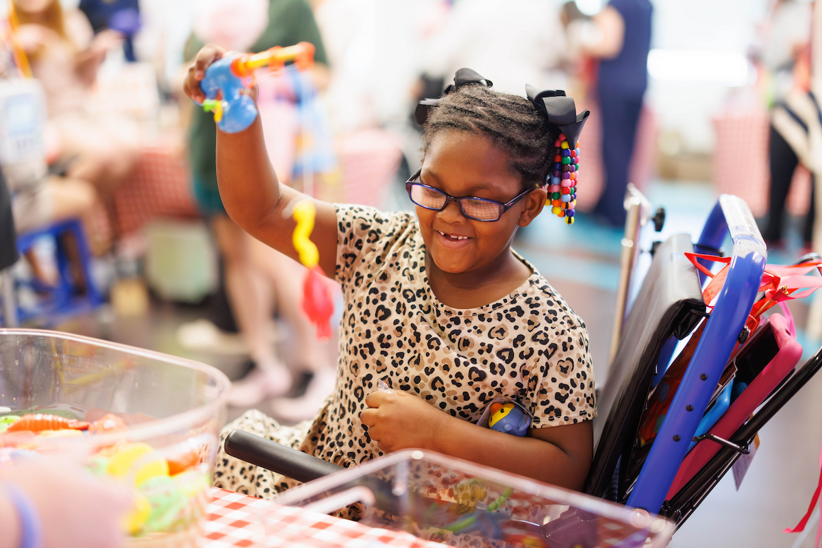 Bella Boyd, 6, of Jackson catches a fish while playing a fair game at Fair with Friends.