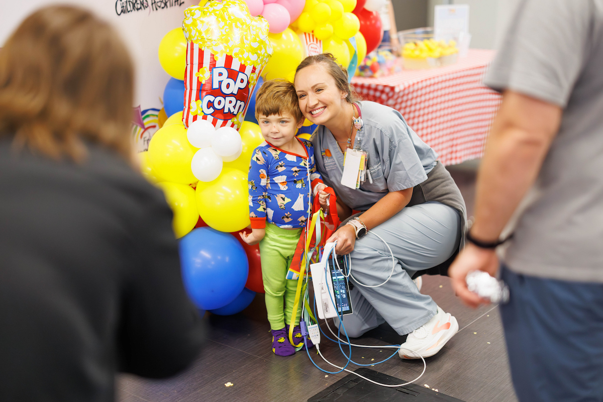 Matthew Bernard, 3, of Jackson takes a Polaroid photo with his nurse.