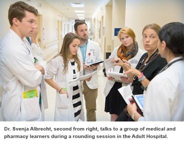 Dr. Svenja Albrecht, second from right, talks to a group of medical and pharmacy students.