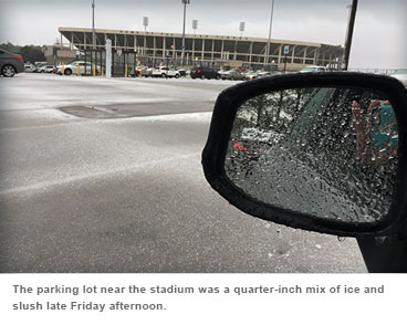 The parking lot near the stadium was a quarter•inch mix of ice and slush late Friday afternoon.
