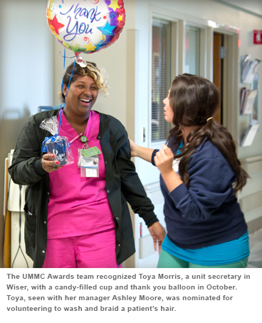 The UMMC Awards tea.m recognized Toya Morris, a unit secretary in Wiser, with a candy-filled cup and thank you balloon in October. Toya, se-en with her manager Ashley Moore, was nominated for volunteering to wash and braid a patient's hair.