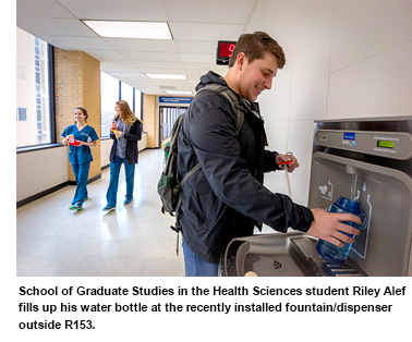 School of Graduate Studies in the Health Sciences student Riley Alef fills up his water bottle at the recently installed fountain/dispenser outside R153.