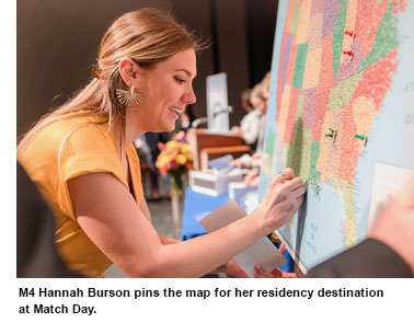 Photo of M4 Hannah Burson pins the map for her residency destination at Match Day.