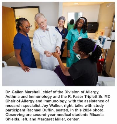 Dr. Gailen Marshall, chief of the Division of Allergy, Asthma and Immunology and the R. Faser Triplett Sr. MD Chair of Allergy and Immunology, with the assistance of research specialist Joy Walker, right, talks with study participant Rachael Duffin, seated, in this 2024 photo. Observing are second-year medical students Micaela Shields, left, and Margaret Miller, center.