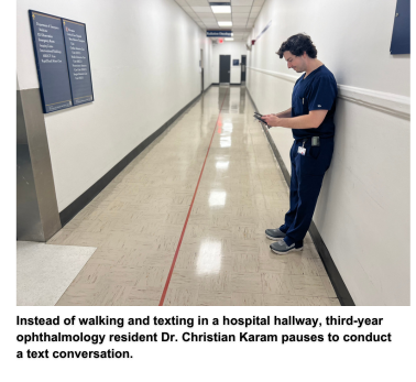 Instead of walking and texting in a hospital hallway, third-year ophthalmology resident Dr. Christian Karam pauses to conduct a text conversation.