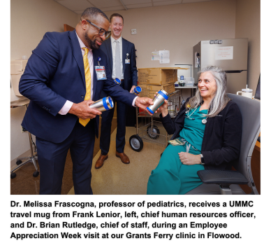 Dr. Melissa Frascogna, professor of pediatrics, receives a UMMC travel mug from Frank Lenior, left, chief human resources officer, and Dr. Brian Rutledge, chief of staff, during an Employee Appreciation Week visit at our Grants Ferry clinic in Flowood.