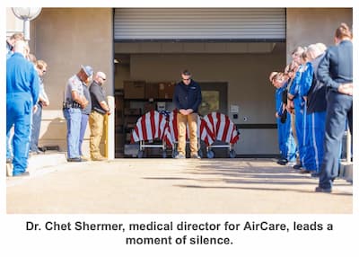 Dr. Chet Shermer, medical director for AirCare, leads a moment of silence.