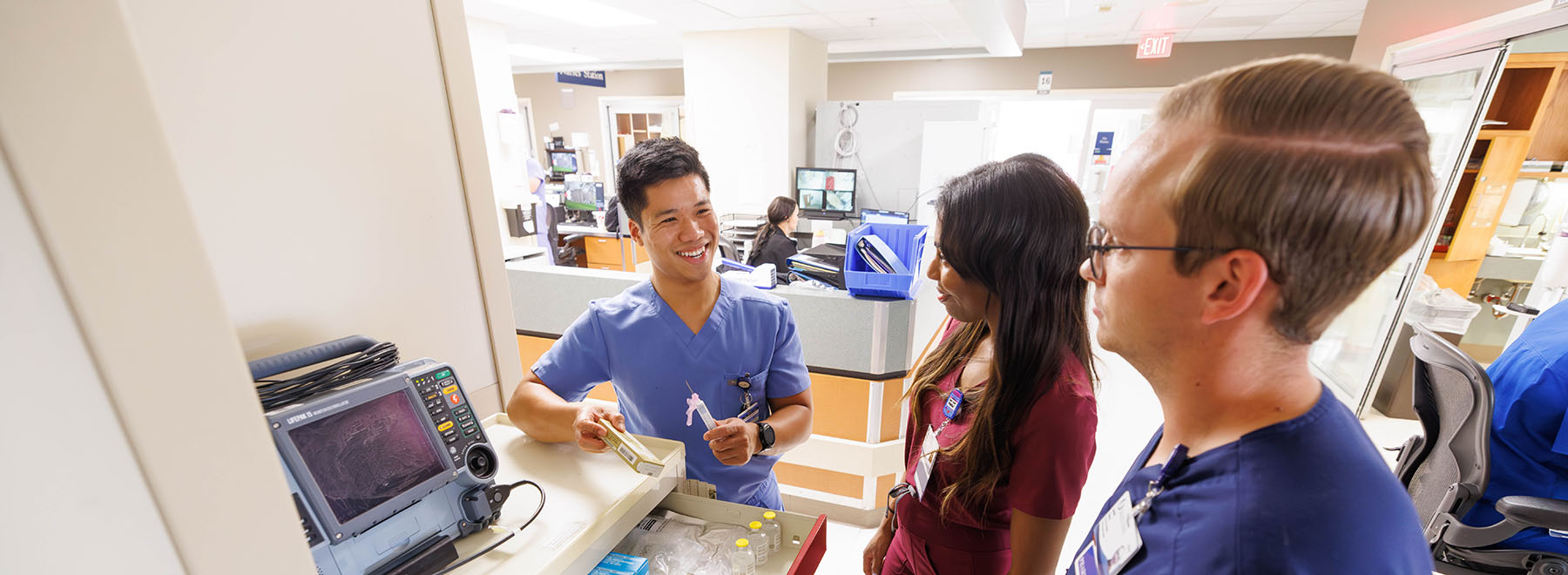 Three UMMC-based pharmacy residents interact on job.