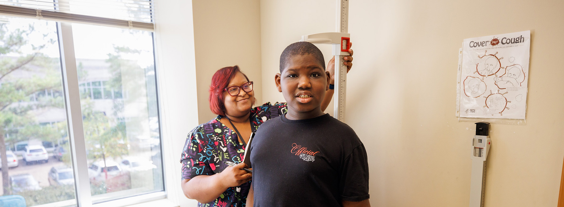 A nurse measures a child's height.