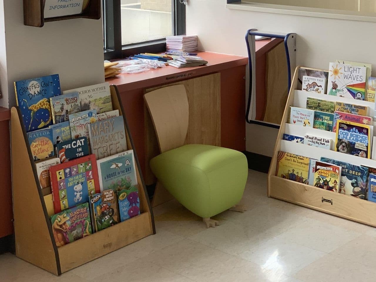 The playroom has magazine racks with numerous copies of kids' publications and books.