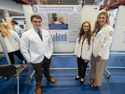 PT students present their poster at a research event.