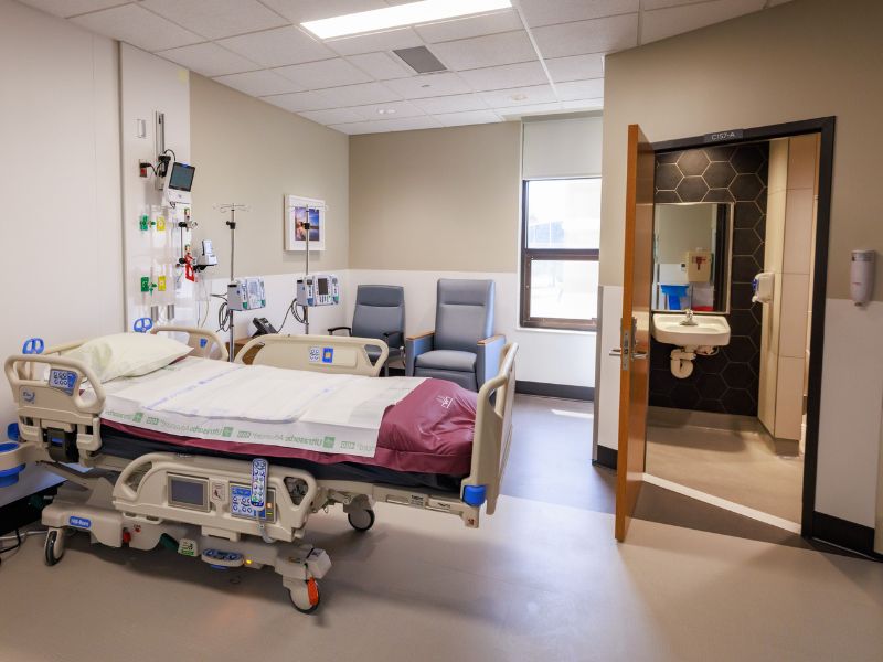 A fully equipped patient room in the Burn Center, showing the bed, recliners and private bath.