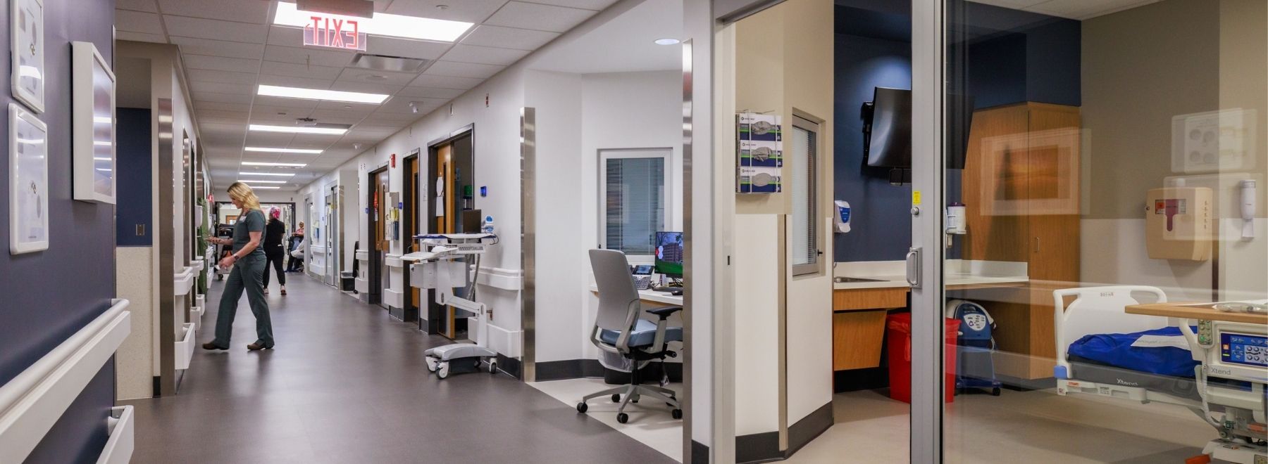 A view down the hall of the Mississippi Burn Center, with a nurse entering information into a computer.