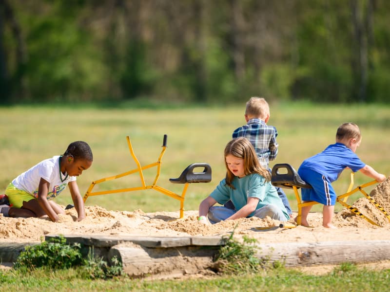 Several children play in a sandbox during Family Fun Day 2026.