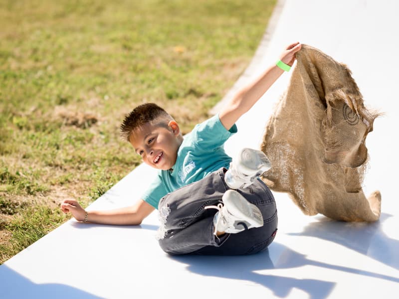 A boy enjoys the slide at Family Fun Day 2026.