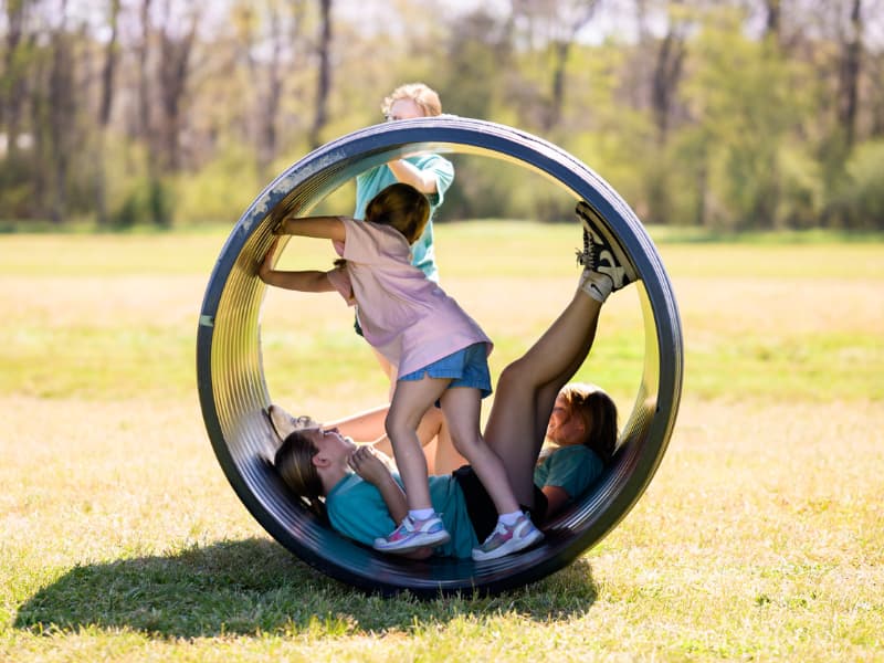 Children play inside an open cylinder at Family Fun Day 2026.