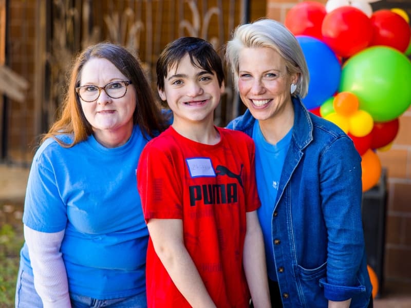 Dr. Laura Humphries visits with a teen and his mom at Family Fun Day
