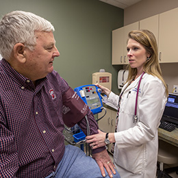 Physician checks a man's blood pressure