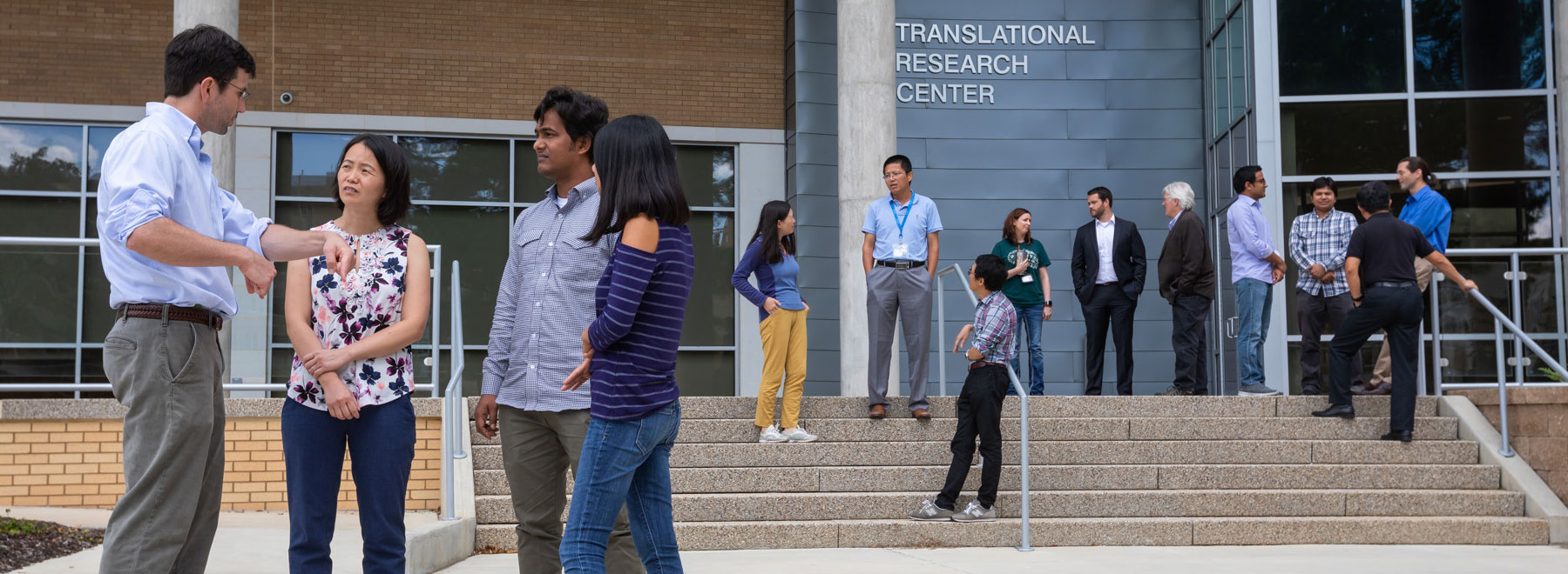 Students and faculty in front of the Translational Research Center